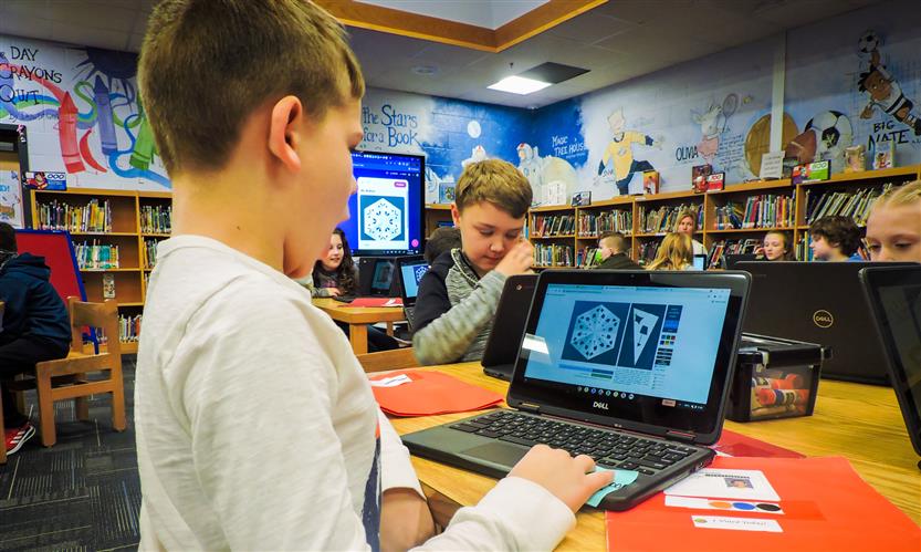 Students on laptops in the library